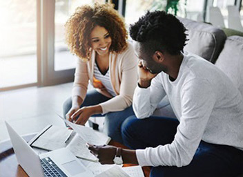 A knowledgeable professional is helping a man manage his bookkeeping.